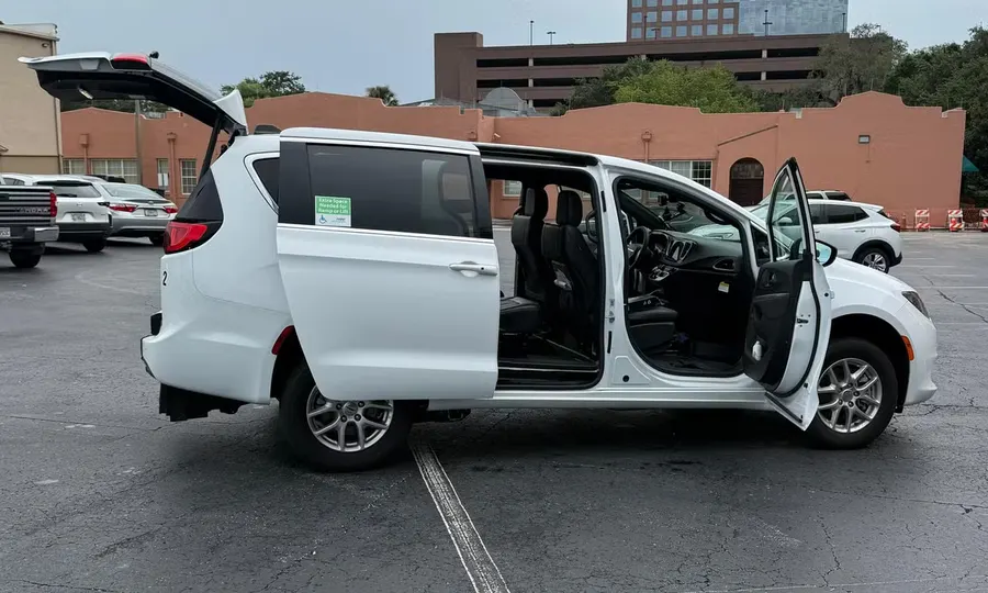 2025 Chrysler Voyager LX wheelchair accessible van Orlando, white exterior view with the rear hatch and sliding door open showing the interior