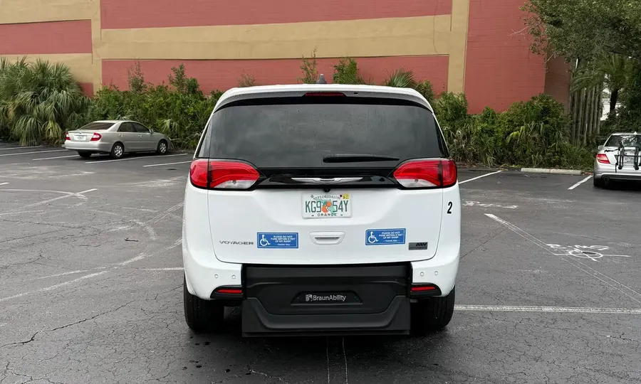 2025 Chrysler Voyager LX wheelchair accessible van Orlando, white rear view with the BraunAbility ramp folded flat