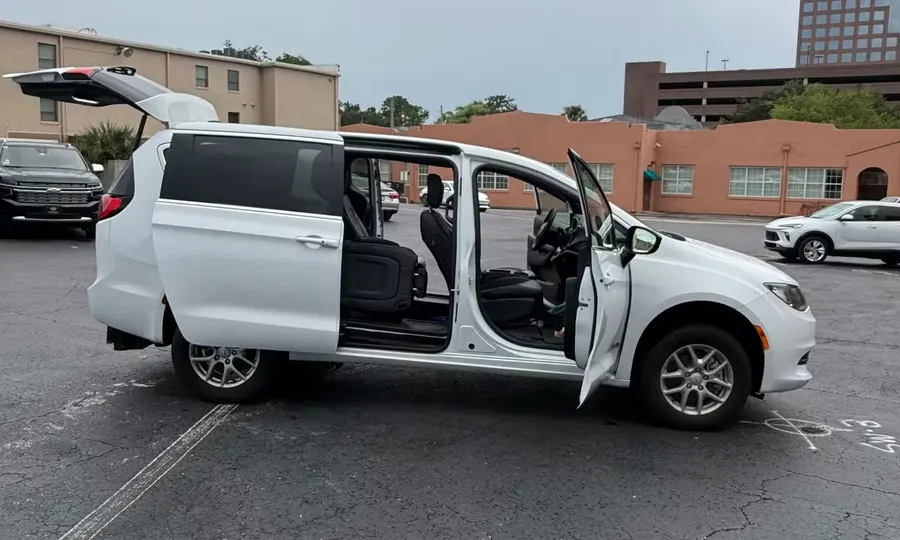 2025 Chrysler Voyager LX wheelchair accessible van Orlando, white exterior view with the sliding door and rear hatch open showing the interior