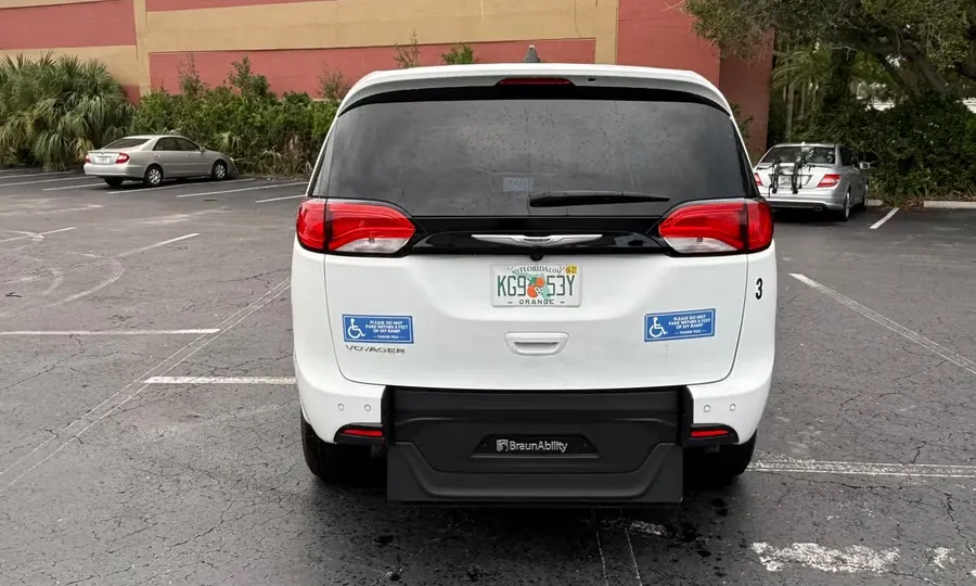 2025 Chrysler Voyager LX wheelchair accessible van Orlando, white rear view with the BraunAbility ramp folded flat