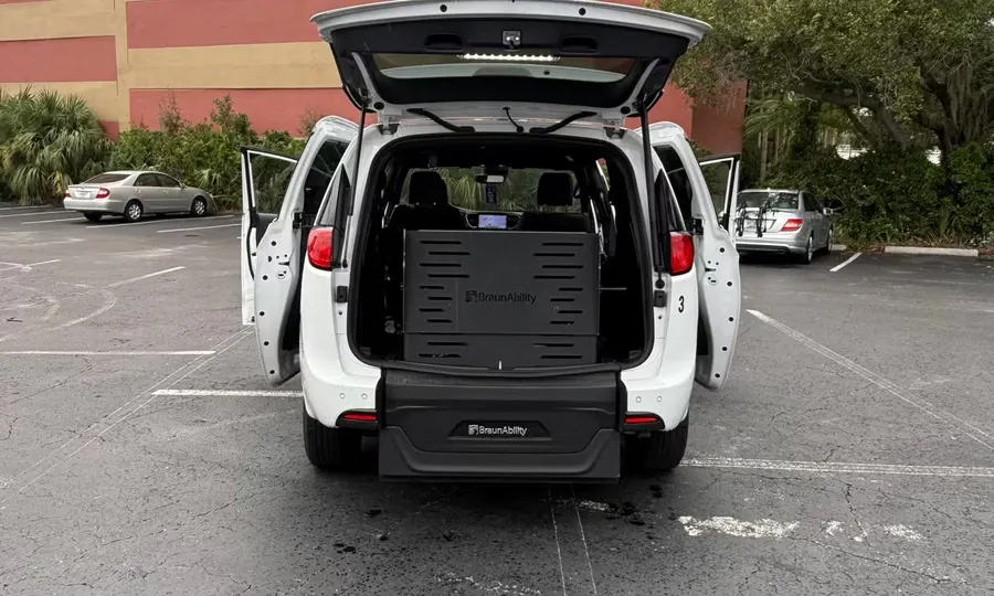 2025 Chrysler Voyager LX wheelchair accessible van Orlando, white rear view with the BraunAbility lift deployed and doors open